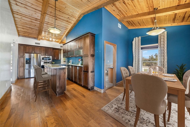 kitchen with decorative backsplash, hanging light fixtures, stainless steel appliances, high vaulted ceiling, and wooden ceiling