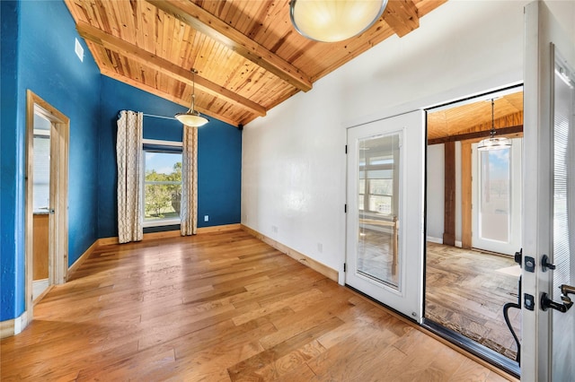 spare room with french doors, light wood-type flooring, wood ceiling, and vaulted ceiling with beams