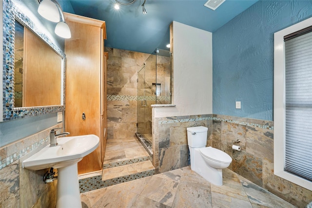 bathroom featuring toilet, tile walls, and tiled shower