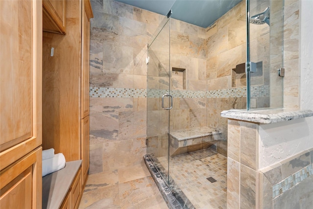 bathroom with a shower with door