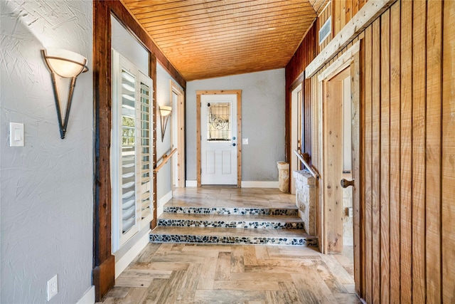 interior space featuring light parquet floors, wood ceiling, and vaulted ceiling