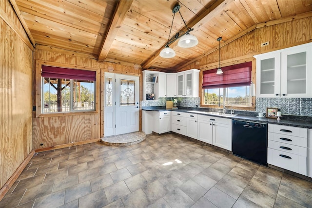 kitchen with black dishwasher, white cabinets, vaulted ceiling with beams, and hanging light fixtures