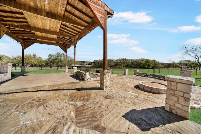 view of patio / terrace with a rural view, a gazebo, and a fire pit