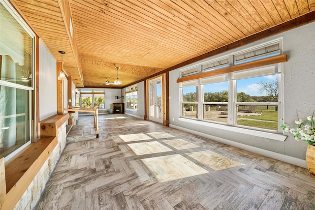 unfurnished sunroom with wood ceiling