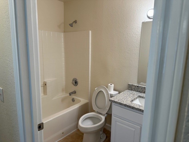 full bathroom featuring tile patterned flooring, shower / washtub combination, vanity, and toilet