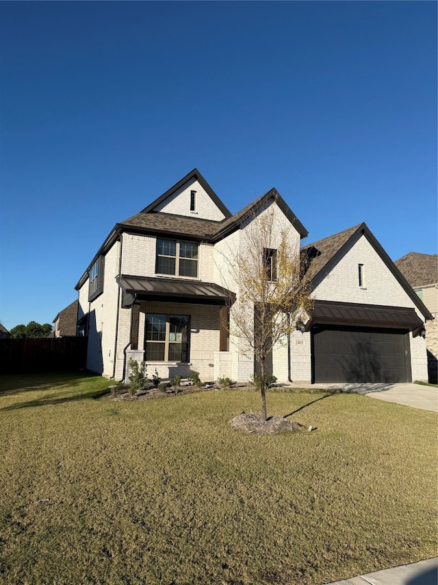 view of front of home featuring a garage and a front yard