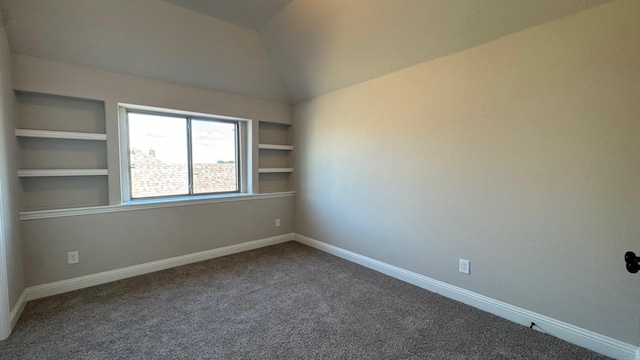 11817 Serval St, Godley, TX 76044 - unfurnished room featuring vaulted ceiling, dark carpet, baseboards, and built in shelves
