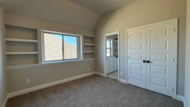 11817 Serval St, Godley, TX 76044 - unfurnished bedroom featuring carpet, lofted ceiling, a closet, ensuite bathroom, and baseboards