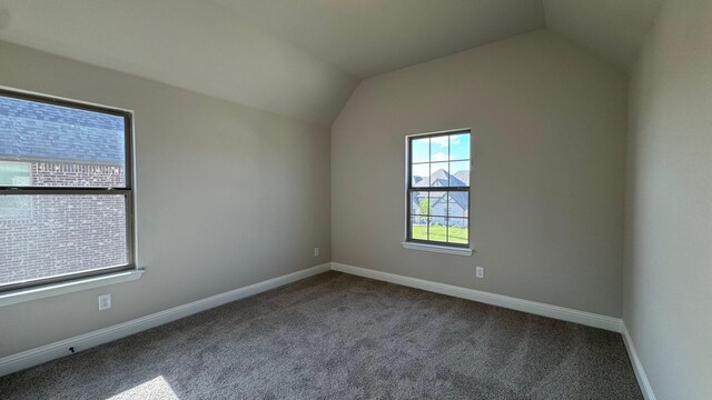 11817 Serval St, Godley, TX 76044 - carpeted empty room featuring lofted ceiling and baseboards