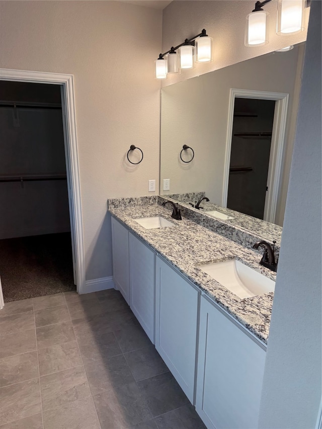 bathroom with tile patterned flooring and vanity