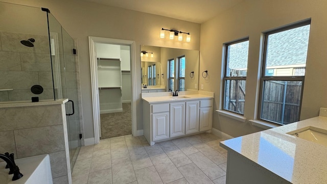 11817 Serval St, Godley, TX 76044 - bathroom with two vanities, a stall shower, and healthy amount of natural light
