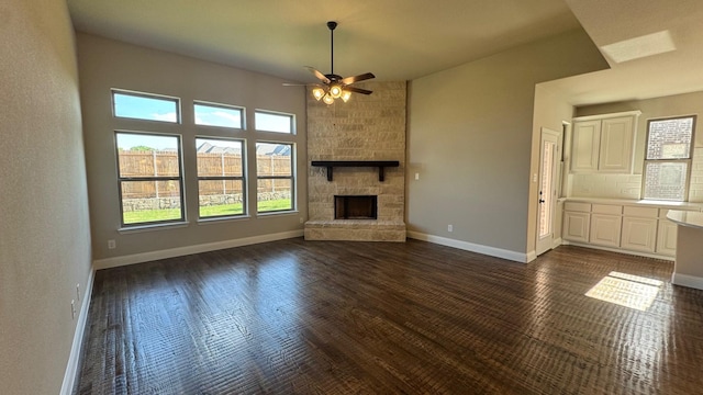 11817 Serval St, Godley, TX 76044 - unfurnished living room featuring ceiling fan, dark wood-style floors, a fireplace, and baseboards