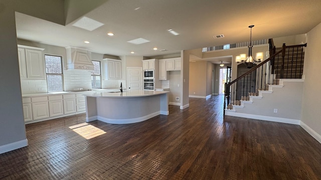 11817 Serval St, Godley, TX 76044 - kitchen featuring custom range hood, stainless steel appliances, a chandelier, white cabinetry, and recessed lighting