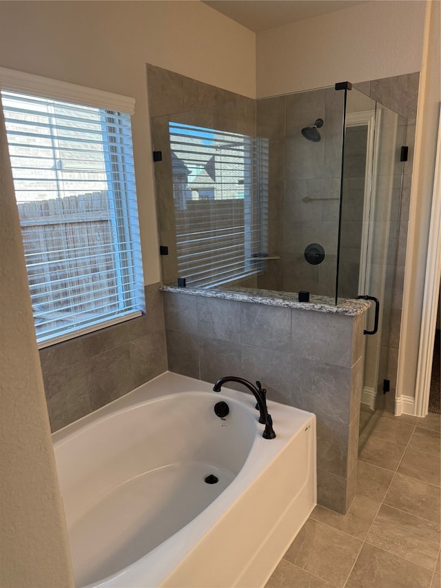 bathroom featuring tile patterned floors and independent shower and bath