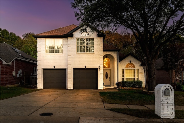 view of front facade with a garage and central AC unit