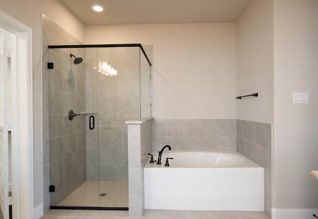 bathroom featuring tile patterned flooring and plus walk in shower