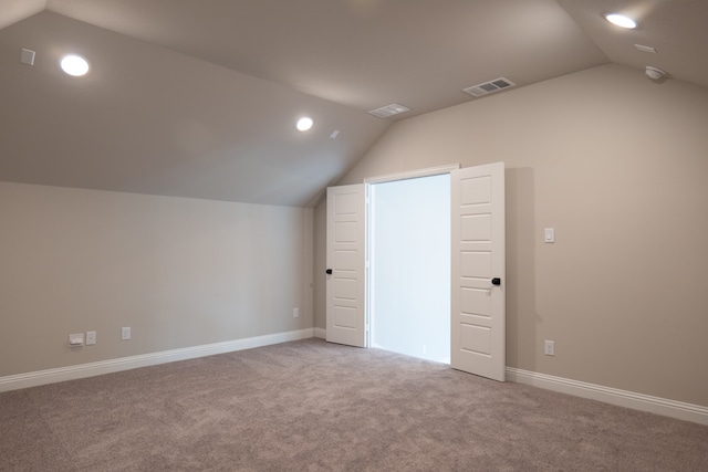 additional living space with carpet floors and vaulted ceiling