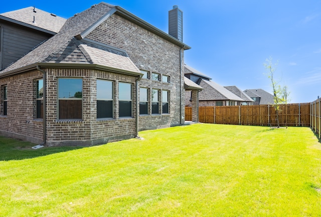 back of house with a yard