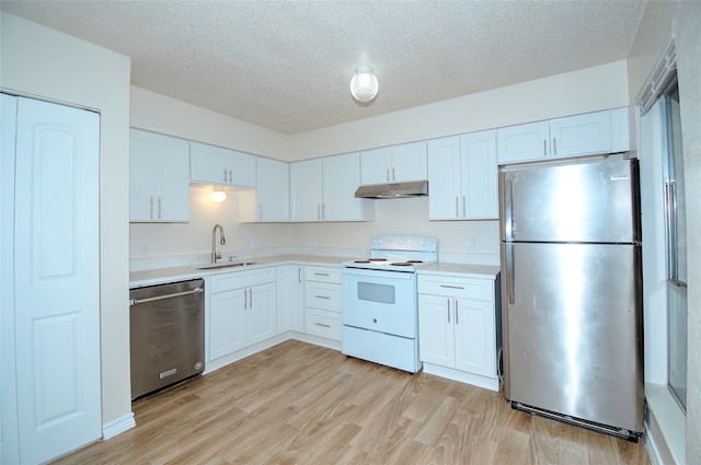 kitchen featuring a textured ceiling, stainless steel appliances, sink, light hardwood / wood-style flooring, and white cabinetry