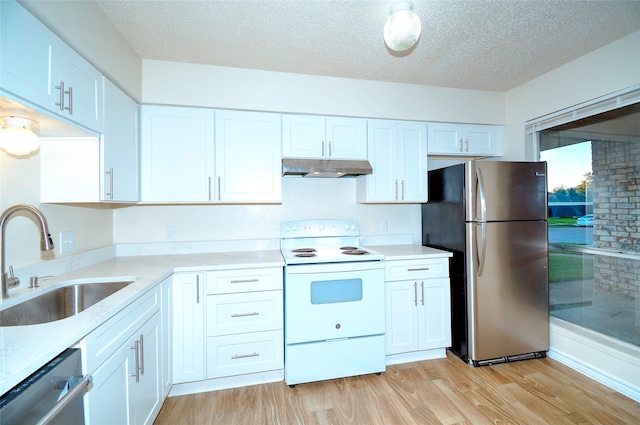 kitchen featuring sink, appliances with stainless steel finishes, a textured ceiling, white cabinets, and light wood-type flooring