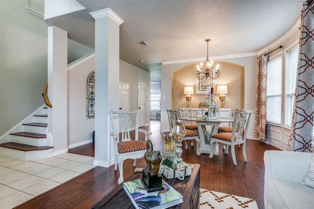 dining room featuring crown molding, a notable chandelier, and light wood-type flooring