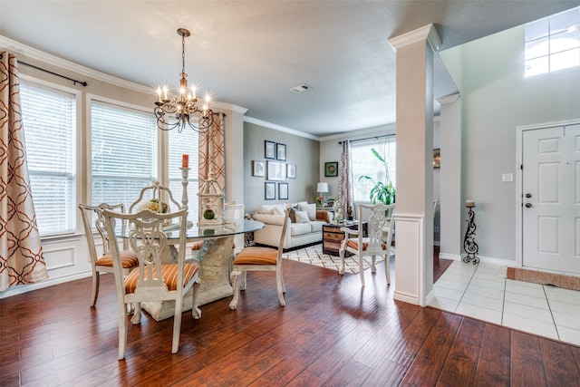 dining room with crown molding, hardwood / wood-style floors, and a notable chandelier