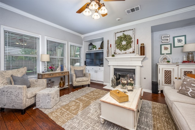 living room featuring crown molding, ceiling fan, and dark hardwood / wood-style floors