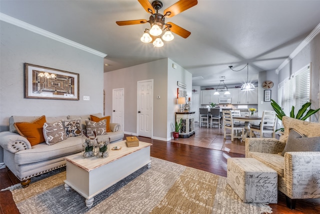 living room featuring ceiling fan, crown molding, and dark wood-type flooring