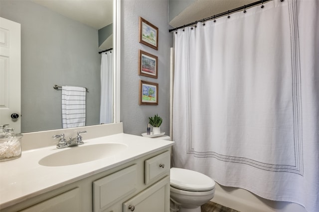 full bathroom with shower / bathtub combination with curtain, vanity, and toilet