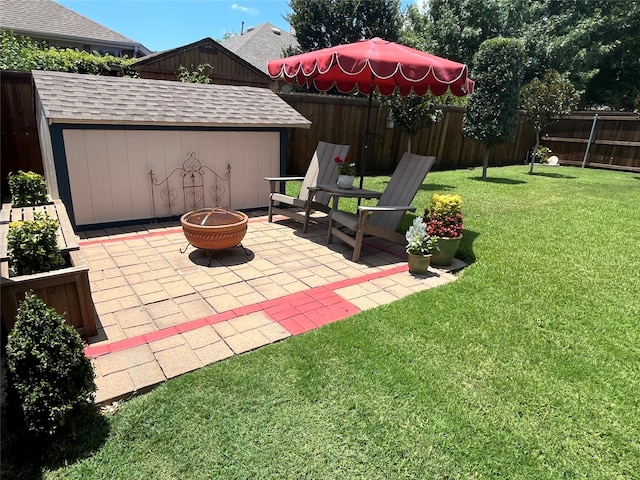 view of patio with a fire pit and a storage shed