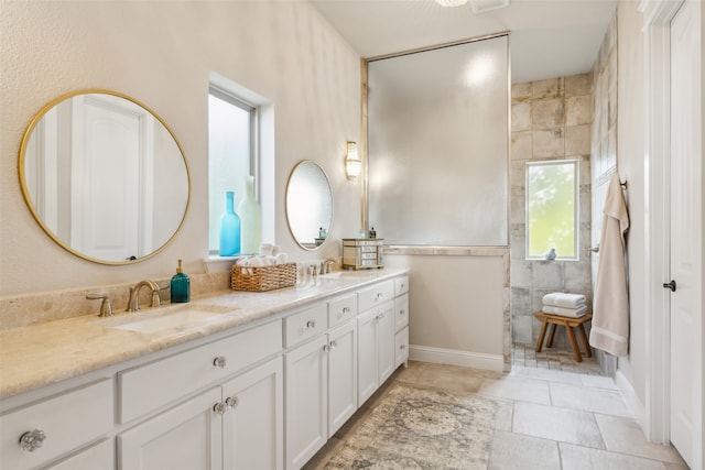 bathroom with tile patterned flooring, vanity, and tile walls