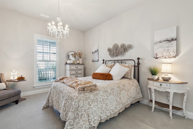 carpeted bedroom with an inviting chandelier