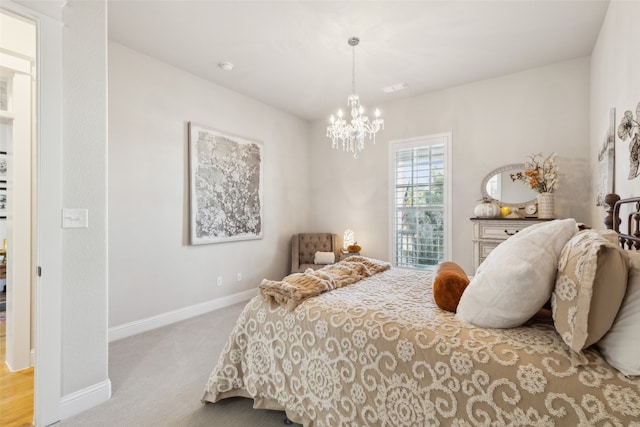 bedroom with light carpet and a notable chandelier