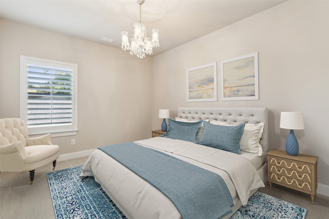 bedroom with carpet flooring and a chandelier