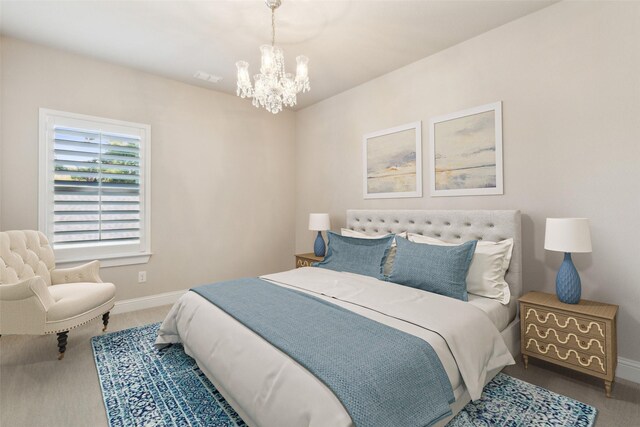 bedroom with carpet flooring and a chandelier