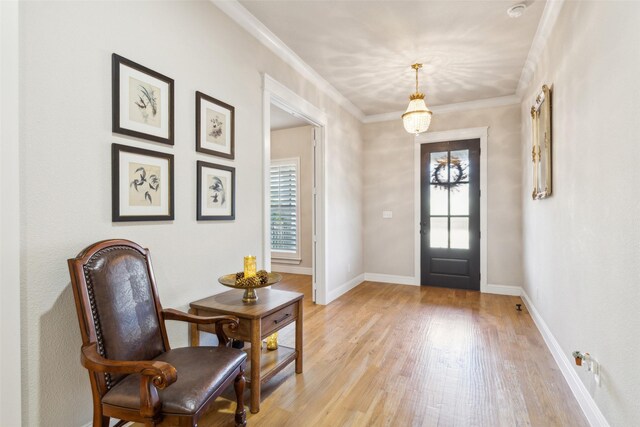 foyer with light hardwood / wood-style flooring and ornamental molding