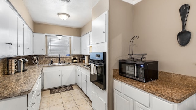 kitchen with backsplash, sink, white cabinets, and black appliances