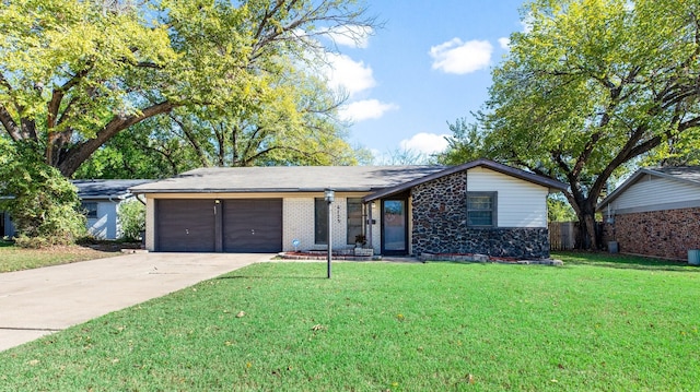 ranch-style home featuring a front yard, brick siding, a garage, and driveway
