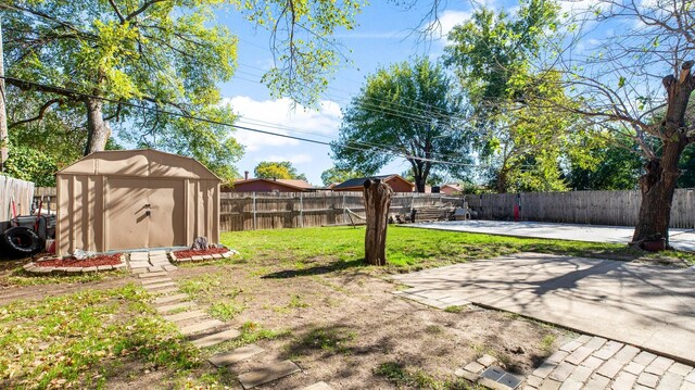 view of yard featuring ac unit, a storage shed, and a patio