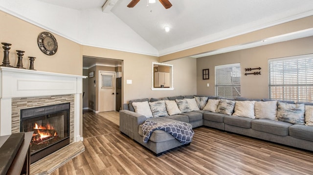 living area featuring a fireplace, beamed ceiling, ceiling fan, high vaulted ceiling, and wood finished floors