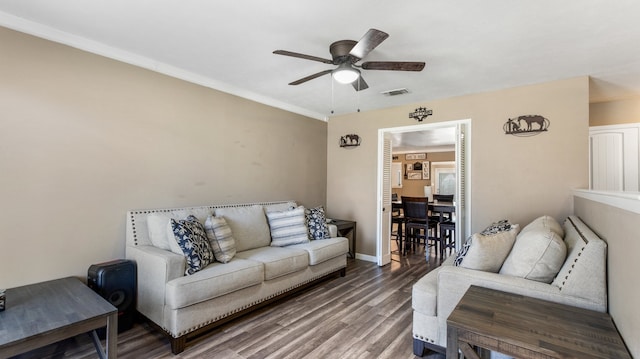 living room featuring wood-type flooring and ceiling fan