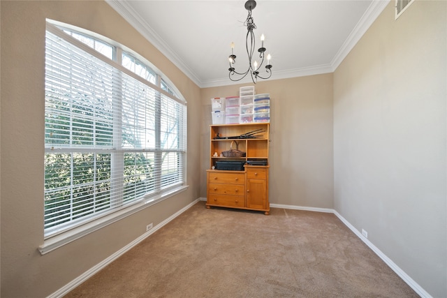 interior space with a chandelier, light colored carpet, crown molding, and a healthy amount of sunlight