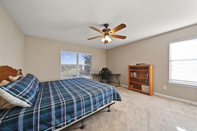 bedroom featuring carpet flooring, multiple windows, and ceiling fan