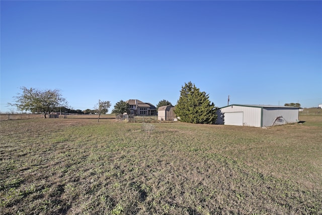 view of yard featuring an outbuilding and a rural view