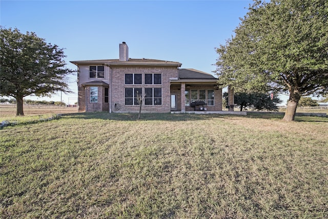 back of house featuring a yard