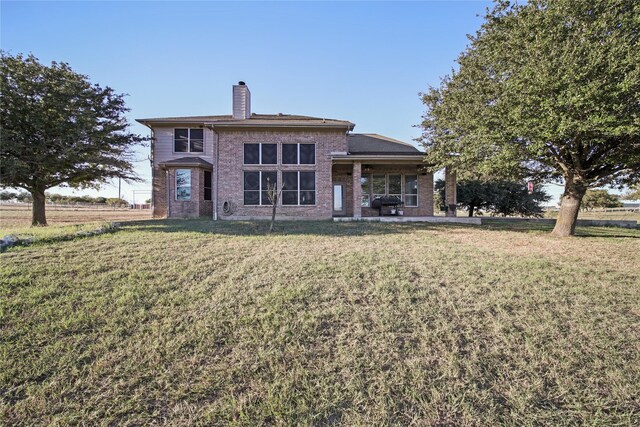 back of house featuring a yard