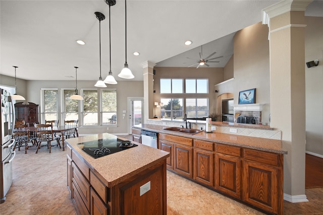 kitchen featuring pendant lighting, a healthy amount of sunlight, sink, and stainless steel appliances