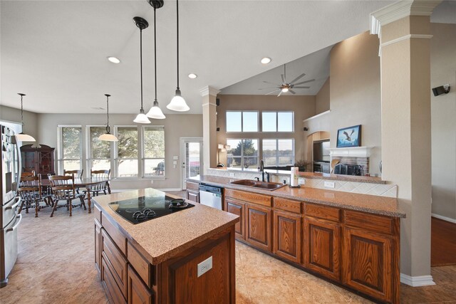 kitchen featuring pendant lighting, a healthy amount of sunlight, sink, and stainless steel appliances