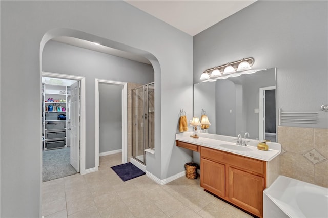 bathroom with plus walk in shower, vanity, and tile patterned floors