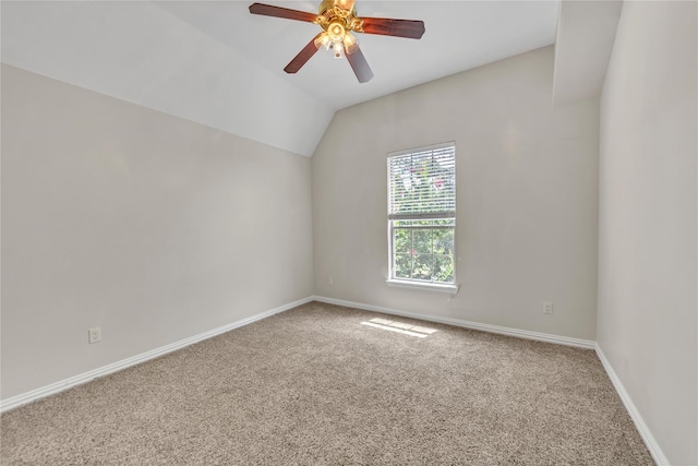 carpeted empty room with ceiling fan and vaulted ceiling